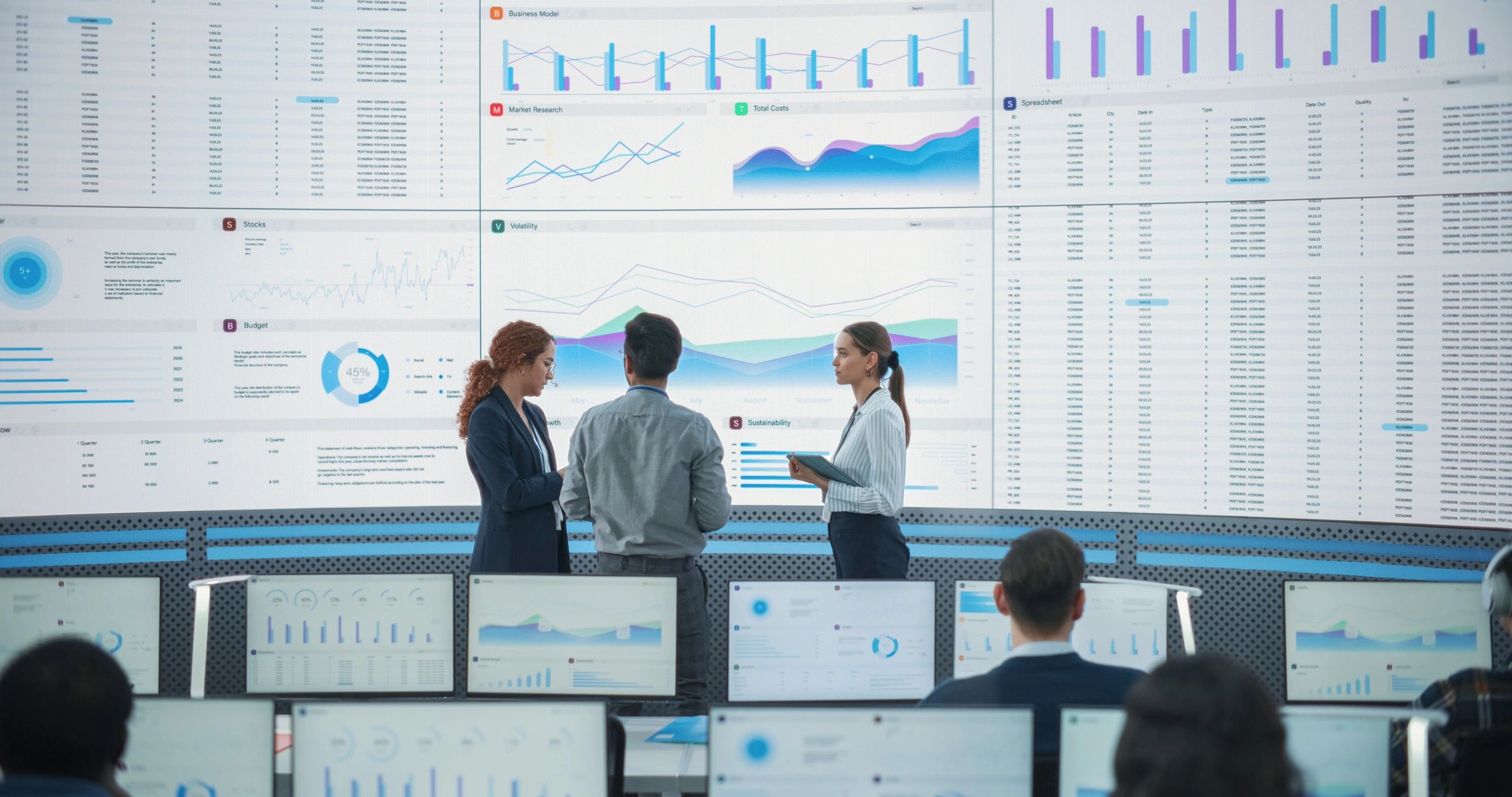 Analysts in a monitoring office reviewing intelligence dashboards