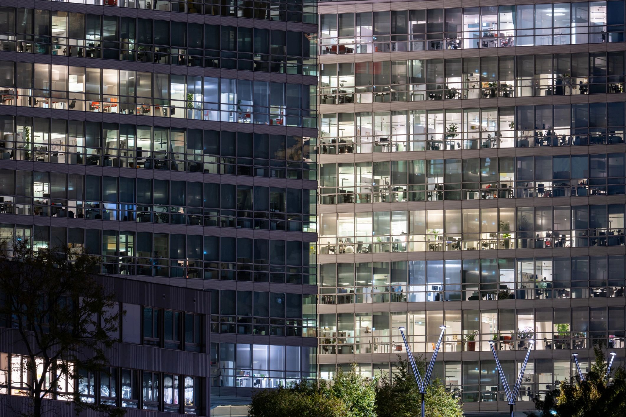 Modern office building at night representing secure, always-on operations.
